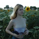 Blonde teen posing in a field of sunflowers