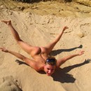 Lovely blonde with sexy body posing on the beach