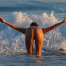 Sexy blonde naked on public beach