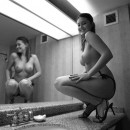 Busty sexy girl posing in the bathroom