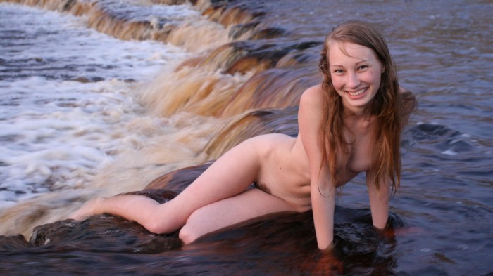 Sweet teen posing naked in the river