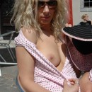 Curly blonde shows boobs and pussy at public cafe