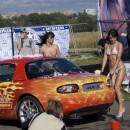 Topless girls washing a car on public show