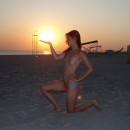 Sporty teen posing topless at the beach