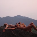 Group of lovely sporty girls posing on the rocks