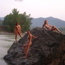 Group of lovely sporty girls posing on the rocks