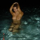 Amazing beautiful curly girl with perfect boobs posing in the sea