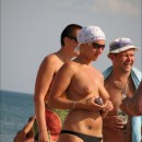 Sweet russian girl walks topless on public beach