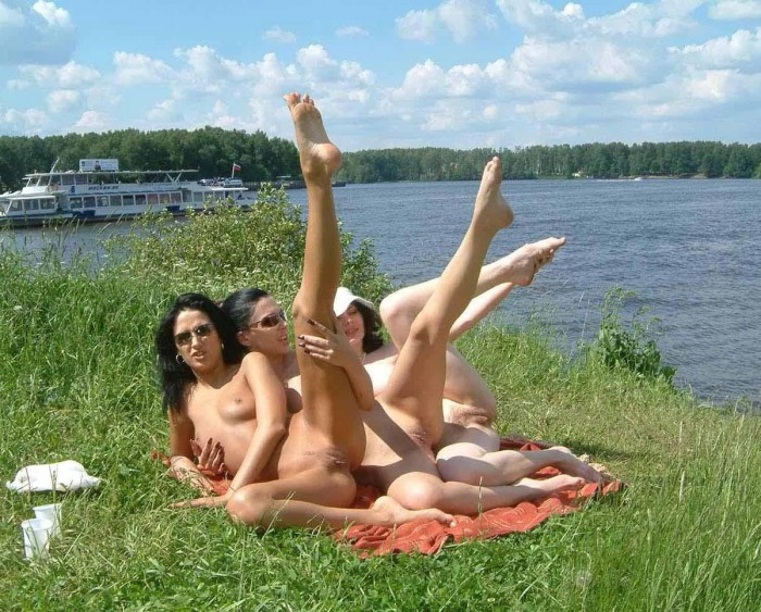 Three russian brunettes shows pussies at public beach