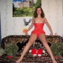 Russian wife with small tits posing topless in red panties on sofa