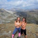 Two young girls posing topless in the beautiful mountains