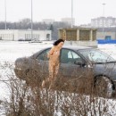 Amazing sporty brunette posing totally naked at winter streets