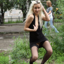Beautiful blonde babe flashes shaved pussy at public park