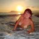 Lovely russian girl with tanlines on boobs posing at sunset beach