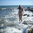 Sporty blonde walks naked at nude beach