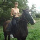 Sweet russian amateur girl posing outdoors with horse