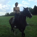 Sweet russian amateur girl posing outdoors with horse