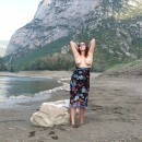 Busty girl spreads legs in mountains