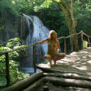 Sexy redhead posing naked at public park