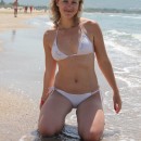 Amateur blonde milf is undressing at beach