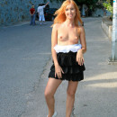 Beautiful redhead girl flashes her goods at public streets