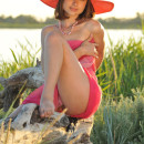 Very sweet girl in big pink hat outdoors