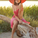 Very sweet girl in big pink hat outdoors