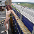 Redhead girl posing on the roof of a supermarket