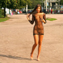 Shameless teen walks only in transparent dress at city center