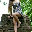 Smiling girl flashes her sweet pussy at park