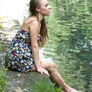 Smiling girl flashes her sweet pussy at park