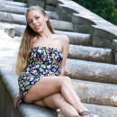 Smiling girl flashes her sweet pussy at park