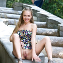 Smiling girl flashes her sweet pussy at park