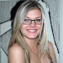 Smiling girl in glasses on the stairs