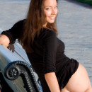 Very beautiful girl takes off her dress at park