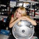 Hot blonde girl is undressing at car shop