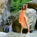 Russian curly teen exposes her naked body at rocks