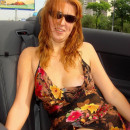 Russian redhead milf riding in a car in a transparent dress