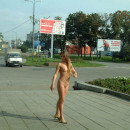 Russian teen with long hair walks naked at city center