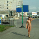 Russian teen with long hair walks naked at city center