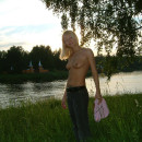 Smiling russian blonde with piercing and tattoo outdoors