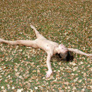 Skinny Russian girl doing gymnastic exercises outdoors without clothes
