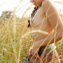 Skinny russian girl with small tits posing naked in the fields