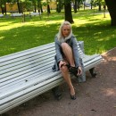 Smiling blonde takes off black panties and flashes body to fisherman