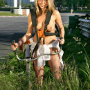 Naked blonde teen mows lawn near public stadium