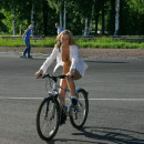 Naked blonde with awesome boobs ride bicycle at public park