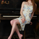Pretty chick with long legs and elegant figure at the piano