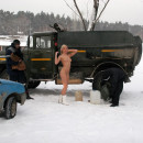 Sporty blonde babe without clothes helps some men fill the car