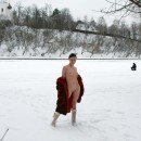 Sweet brunette with nice boobs demonstrates her body near frozen river
