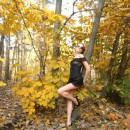 Tall russian girl in sexy dress posing at forest
